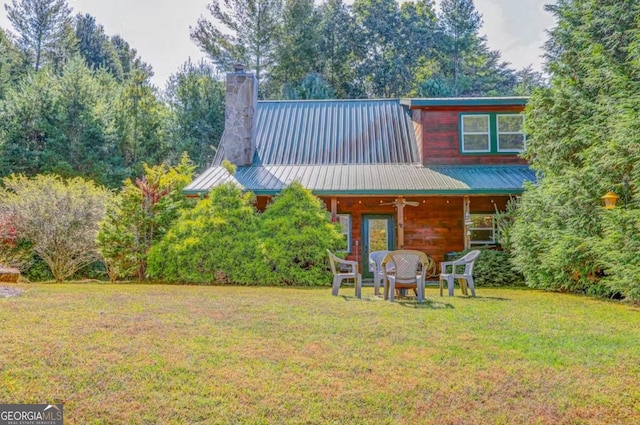 76 River Forest Pl Unit D, Suches, GA 30572 - rear view of house featuring a lawn, a chimney, metal roof, and view of wooded area