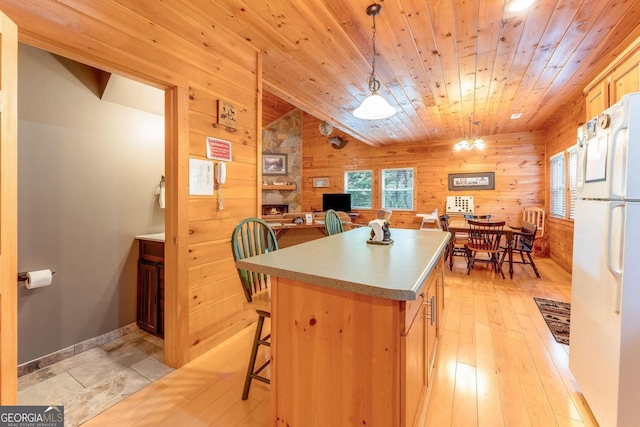 76 River Forest Pl Unit D, Suches, GA 30572 - kitchen with freestanding refrigerator, wooden walls, a center island, wood ceiling, and hanging light fixtures
