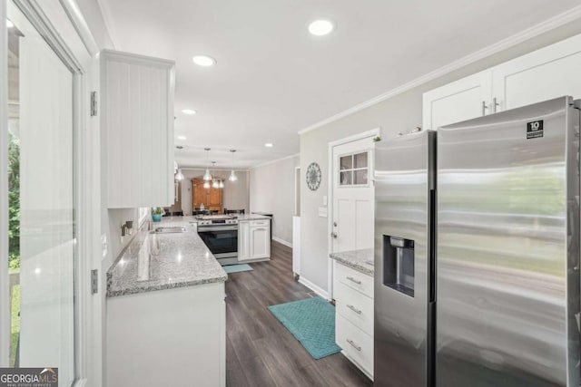 156 Sims St, Winder, GA 30680 - kitchen featuring stainless steel appliances, a peninsula, white cabinets, crown molding, and dark wood-style flooring