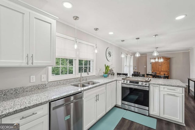 156 Sims St, Winder, GA 30680 - kitchen with a sink, stainless steel appliances, dark wood-style flooring, a peninsula, and white cabinets