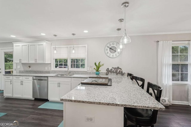 156 Sims St, Winder, GA 30680 - kitchen with dishwasher, a sink, a breakfast bar, ornamental molding, and a peninsula