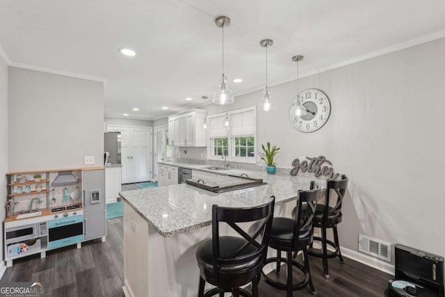156 Sims St, Winder, GA 30680 - kitchen featuring a sink, a peninsula, stainless steel dishwasher, dark wood-style floors, and ornamental molding