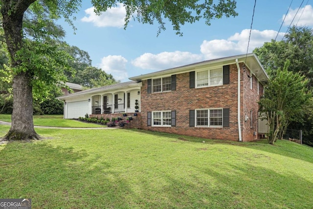 156 Sims St, Winder, GA 30680 - split level home featuring an attached garage, brick siding, and a front lawn