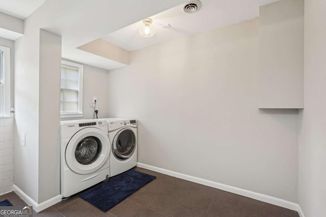 156 Sims St, Winder, GA 30680 - laundry area with washing machine and clothes dryer, baseboards, and dark tile patterned floors