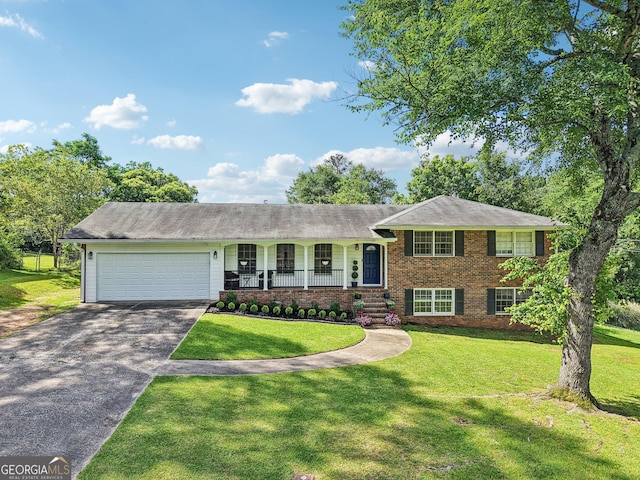 156 Sims St, Winder, GA 30680 - split level home with a garage, brick siding, a porch, and a front lawn