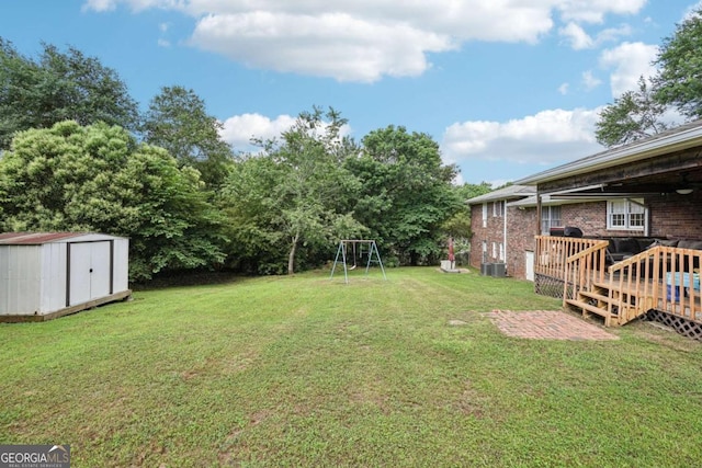 156 Sims St, Winder, GA 30680 - view of grassy yard featuring cooling unit and a wooden deck