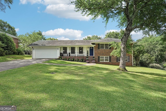 156 Sims St, Winder, GA 30680 - tri-level home featuring driveway, brick siding, an attached garage, and a front lawn