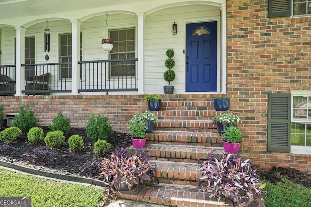 156 Sims St, Winder, GA 30680 - property entrance featuring covered porch and brick siding