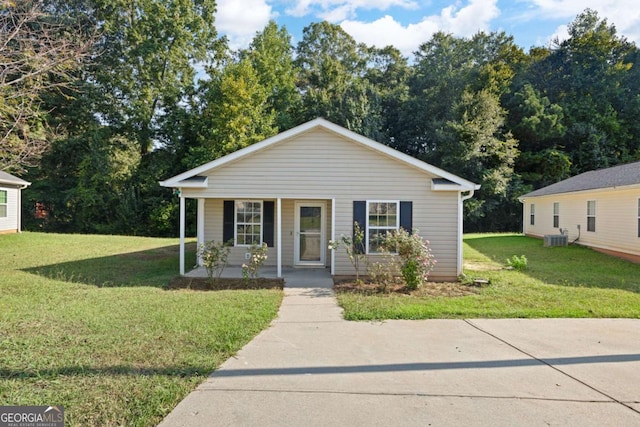 3645 Ten Oaks Cir, Powder Springs, GA 30127 - bungalow-style home with covered porch, a front lawn, central AC unit, and view of wooded area