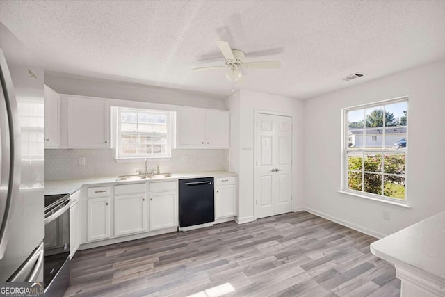 3645 Ten Oaks Cir, Powder Springs, GA 30127 - kitchen featuring dishwasher, a sink, stainless steel range with electric cooktop, a textured ceiling, and white cabinets