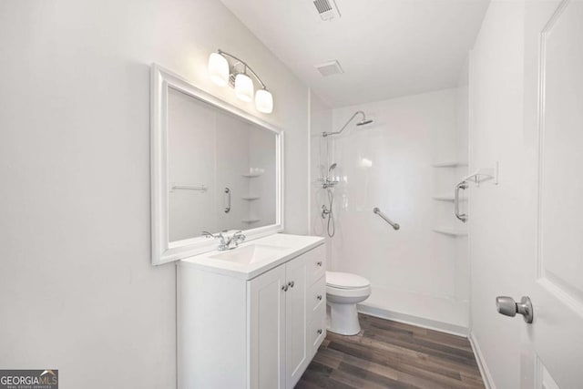 3645 Ten Oaks Cir, Powder Springs, GA 30127 - bathroom featuring toilet, wood finished floors, a shower, and vanity