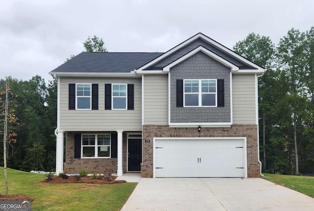 609 Lobelia Way, Locust Grove, GA 30248 - craftsman house featuring brick siding, driveway, a garage, and a front yard