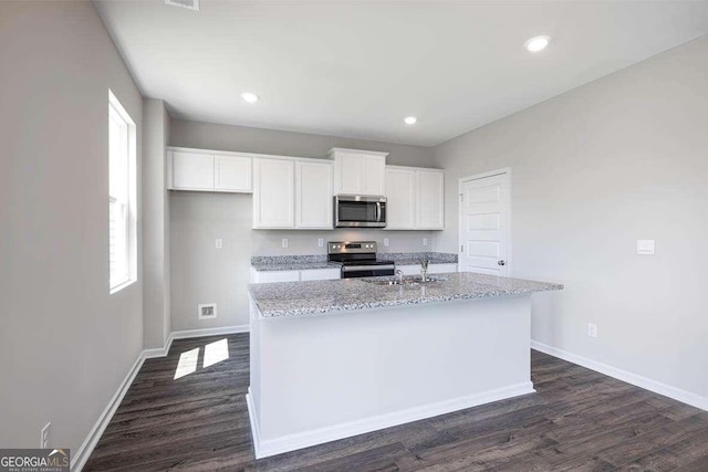 609 Lobelia Way, Locust Grove, GA 30248 - kitchen with stainless steel appliances, white cabinets, baseboards, plenty of natural light, and recessed lighting