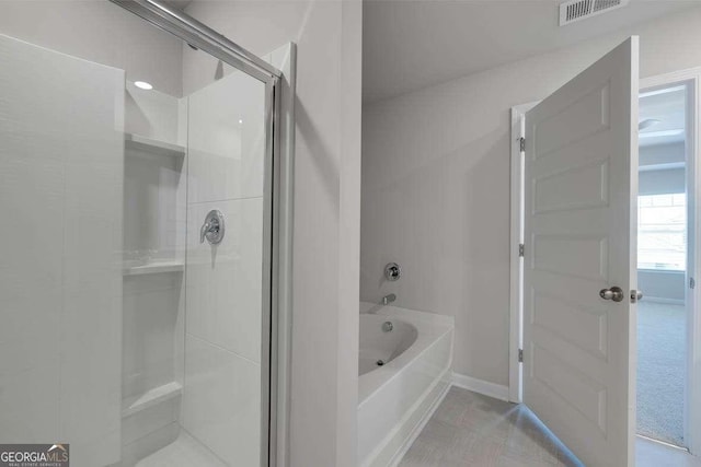 609 Lobelia Way, Locust Grove, GA 30248 - full bathroom featuring a shower stall, a bath, and baseboards