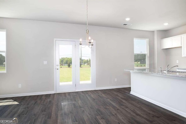 609 Lobelia Way, Locust Grove, GA 30248 - unfurnished dining area with dark wood finished floors, a chandelier, a sink, baseboards, and recessed lighting