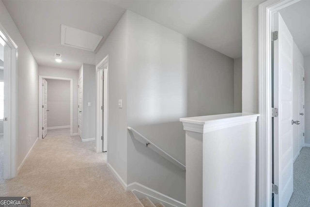609 Lobelia Way, Locust Grove, GA 30248 - hallway with an upstairs landing, carpet floors, and baseboards