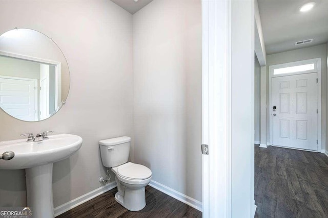 609 Lobelia Way, Locust Grove, GA 30248 - half bathroom with wood finished floors, baseboards, and toilet