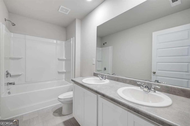 609 Lobelia Way, Locust Grove, GA 30248 - bathroom with toilet, double vanity, and washtub / shower combination