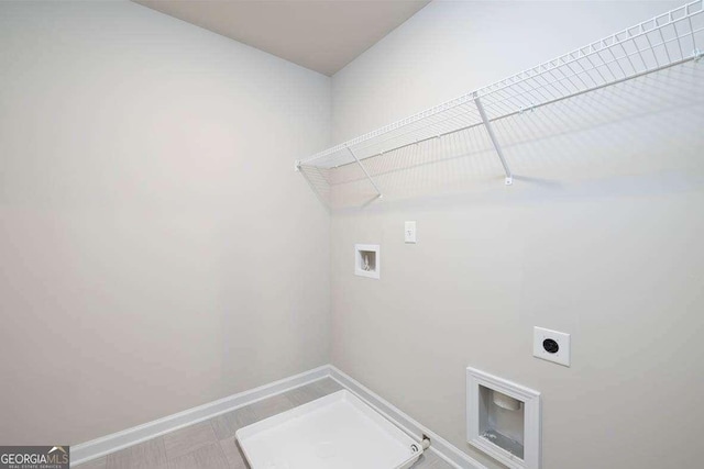 609 Lobelia Way, Locust Grove, GA 30248 - laundry room featuring hookup for an electric dryer, hookup for a washing machine, baseboards, and gas dryer hookup