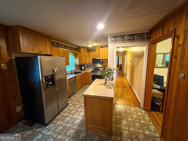 5141 Hiram Lithia Springs Rd, Powder Springs, GA 30127 - kitchen with stainless steel appliances, a sink, brown cabinets, a center island, and wooden counters