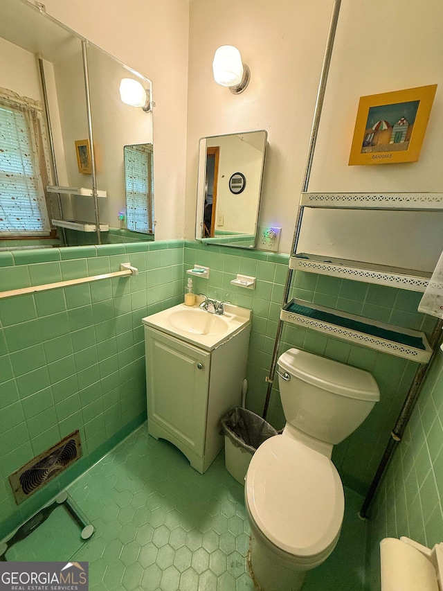 5141 Hiram Lithia Springs Rd, Powder Springs, GA 30127 - bathroom featuring tile walls, tile patterned flooring, vanity, a wainscoted wall, and toilet