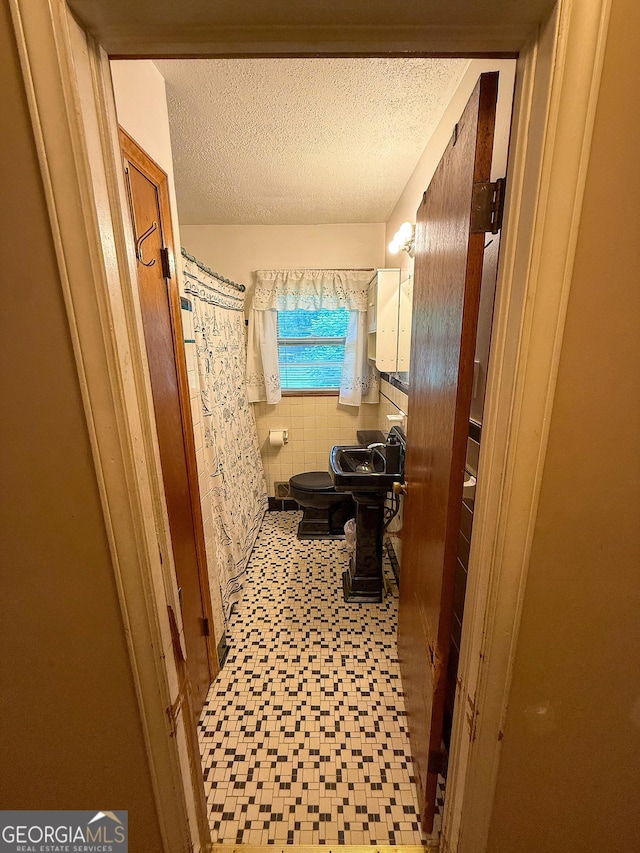 5141 Hiram Lithia Springs Rd, Powder Springs, GA 30127 - bathroom with tile patterned floors, a textured ceiling, toilet, and a shower with shower curtain