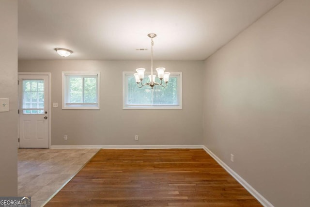 4345 Kimball Rd SW, Atlanta, GA 30331 - unfurnished dining area with a chandelier and wood finished floors