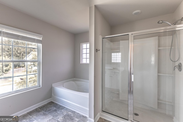 162 Cool Creek Ct, Dallas, GA 30132 - bathroom with a stall shower, a bath, baseboards, and stone finish flooring