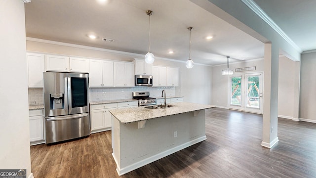 162 Cool Creek Ct, Dallas, GA 30132 - kitchen with appliances with stainless steel finishes, backsplash, an island with sink, ornamental molding, and white cabinetry