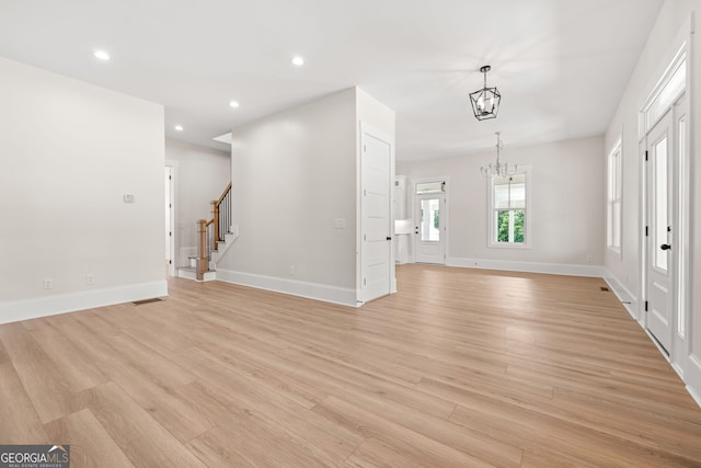 401 Roper Dr, Clarkesville, GA 30523 - unfurnished living room featuring a chandelier, light wood-style floors, stairway, baseboards, and recessed lighting