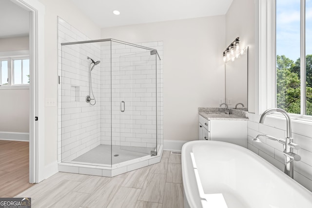 401 Roper Dr, Clarkesville, GA 30523 - full bathroom featuring a soaking tub, a shower stall, plenty of natural light, vanity, and recessed lighting