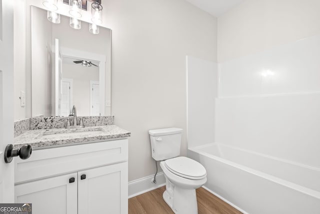 401 Roper Dr, Clarkesville, GA 30523 - bathroom featuring wood finished floors, toilet, vanity, baseboards, and bathing tub / shower combination
