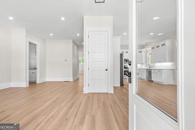 401 Roper Dr, Clarkesville, GA 30523 - spare room featuring light wood-style floors, recessed lighting, baseboards, and a sink
