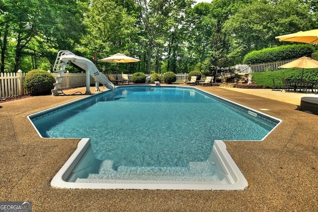 270 Stone Ln, Blue Ridge, GA 30513 - view of swimming pool featuring a water slide, a fenced backyard, a patio area, and view of scattered trees