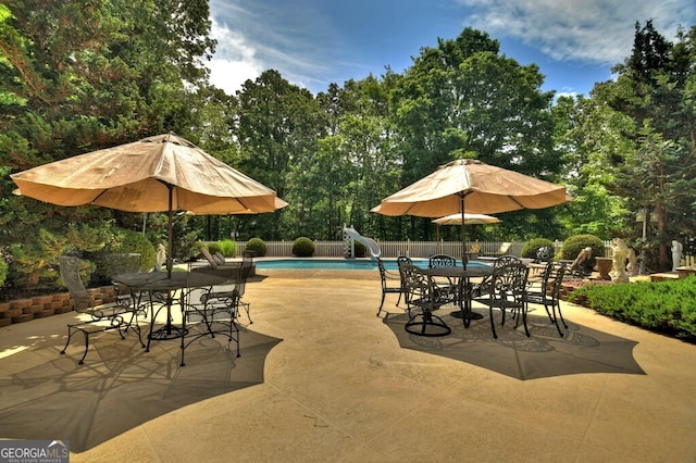 270 Stone Ln, Blue Ridge, GA 30513 - view of pool with a water slide, outdoor dining space, a patio area, and view of wooded area