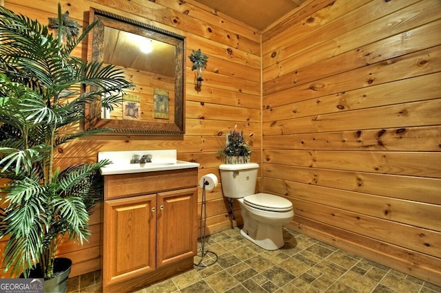 270 Stone Ln, Blue Ridge, GA 30513 - half bathroom featuring wood walls, vanity, toilet, and stone finish flooring