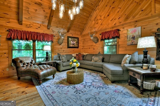 270 Stone Ln, Blue Ridge, GA 30513 - living room with healthy amount of natural light, a chandelier, hardwood / wood-style floors, wood walls, and high vaulted ceiling