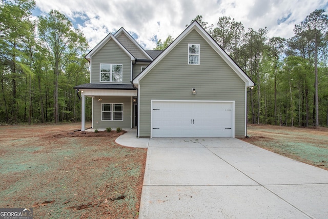 628 Grove St, Barnesville, GA 30204 - traditional-style house featuring driveway, an attached garage, and covered porch