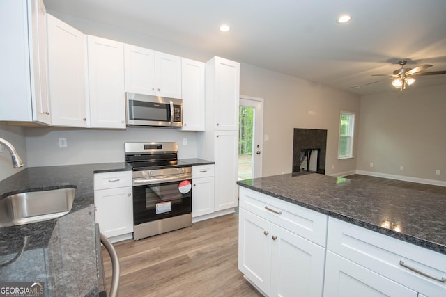 628 Grove St, Barnesville, GA 30204 - kitchen with stainless steel appliances, a sink, white cabinetry, ceiling fan, and recessed lighting