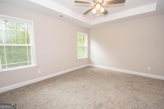 628 Grove St, Barnesville, GA 30204 - spare room with a raised ceiling, a ceiling fan, carpet floors, and baseboards