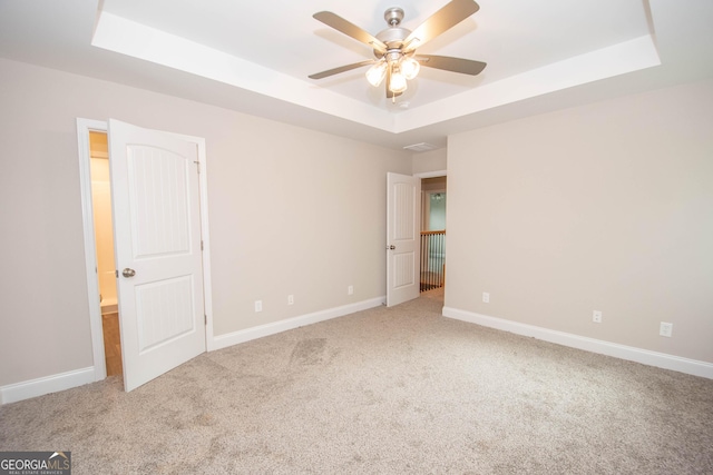 628 Grove St, Barnesville, GA 30204 - unfurnished bedroom with a raised ceiling, carpet flooring, and baseboards