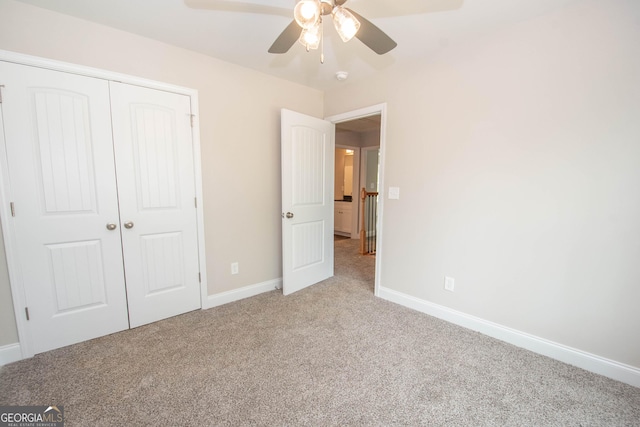 628 Grove St, Barnesville, GA 30204 - unfurnished bedroom with carpet, a closet, baseboards, and a ceiling fan