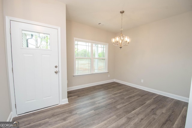 628 Grove St, Barnesville, GA 30204 - entrance foyer featuring a chandelier, healthy amount of natural light, dark wood-style flooring, and baseboards