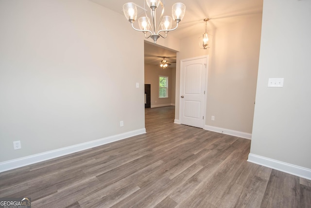628 Grove St, Barnesville, GA 30204 - unfurnished room with a chandelier, wood finished floors, baseboards, and a ceiling fan
