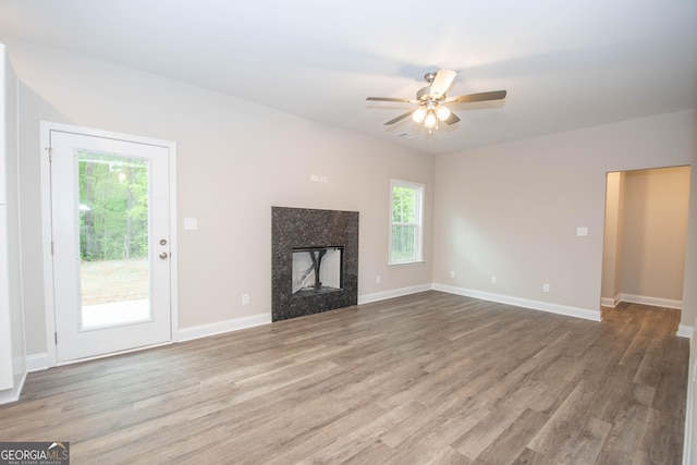 628 Grove St, Barnesville, GA 30204 - unfurnished living room with wood finished floors, ceiling fan, a high end fireplace, and baseboards