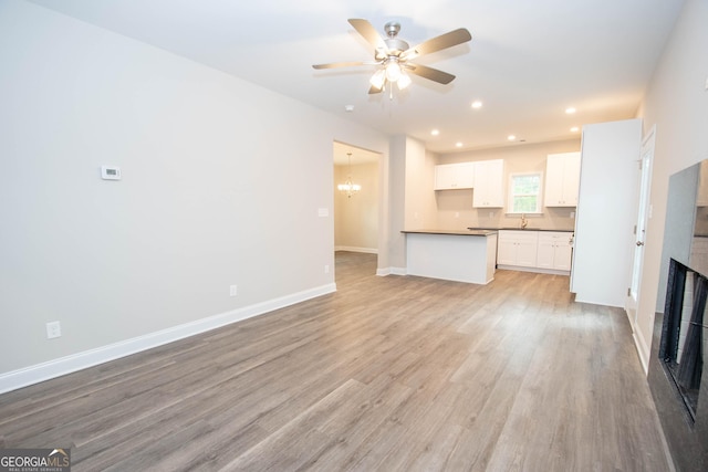 628 Grove St, Barnesville, GA 30204 - unfurnished living room with a fireplace, ceiling fan, light wood-style floors, baseboards, and recessed lighting