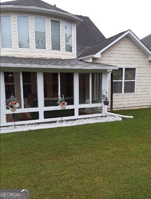 7314 Basalt Dr, Union City, GA 30291 - back of property with roof with shingles, a yard, and a sunroom