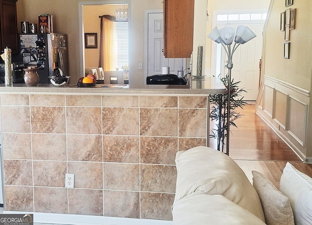 7314 Basalt Dr, Union City, GA 30291 - kitchen with freestanding refrigerator, wood finished floors, and a wainscoted wall