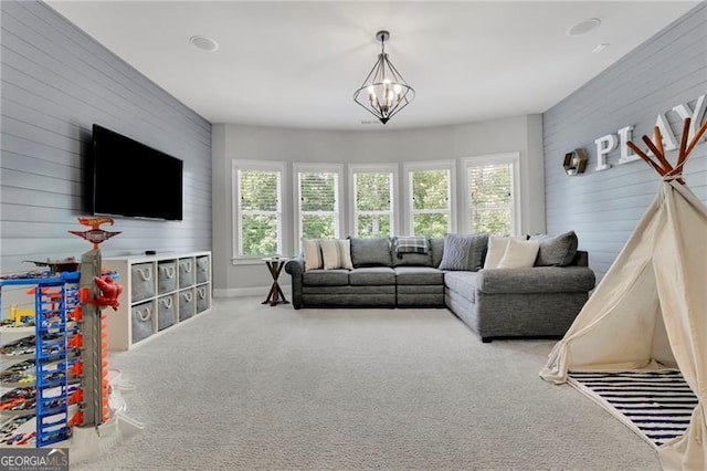 3330 Riverwalk Way, Cumming, GA 30040 - living area featuring plenty of natural light, carpet floors, a chandelier, wood walls, and baseboards