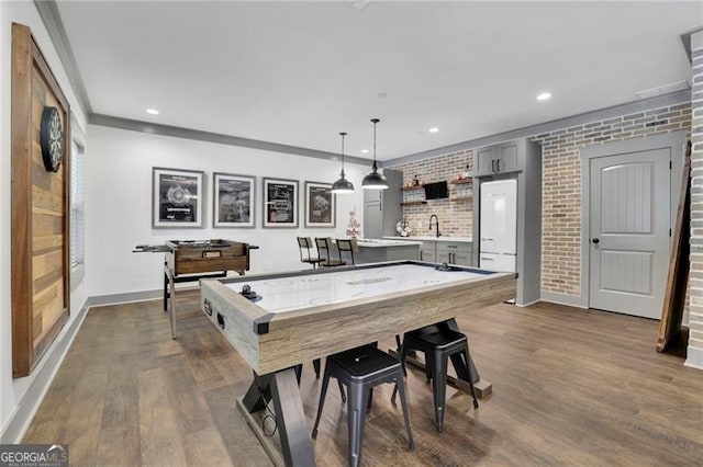 3330 Riverwalk Way, Cumming, GA 30040 - rec room with a sink, dark wood-type flooring, brick wall, baseboards, and recessed lighting